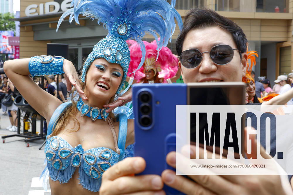 Dancers perform samba show summer festival in Seoul Dancers from Lotte World, a South Korean theme park, pose for photos with visitors after performing a samba show during a summer festival promotional event in the Myeongdong shopping district in Seoul, South Korea, on July 01, 2026. Seoul South Korea