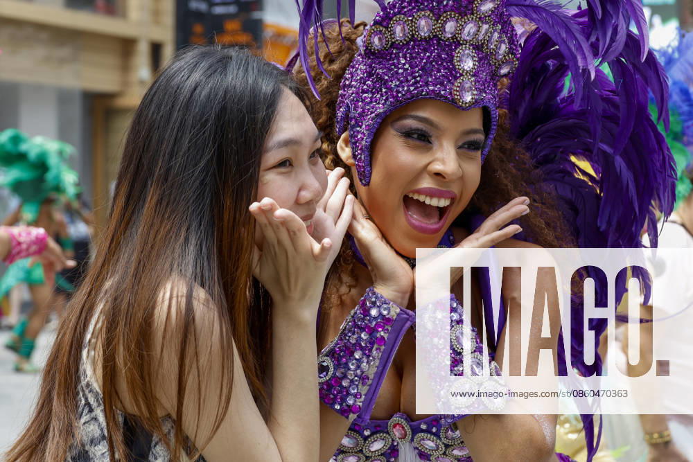Dancers perform samba show summer festival in Seoul Dancers from Lotte World, a South Korean theme park, pose for photos with visitors after performing a samba show during a summer festival promotional event in the Myeongdong shopping district in Seoul, South Korea, on July 01, 2026. Seoul South Korea