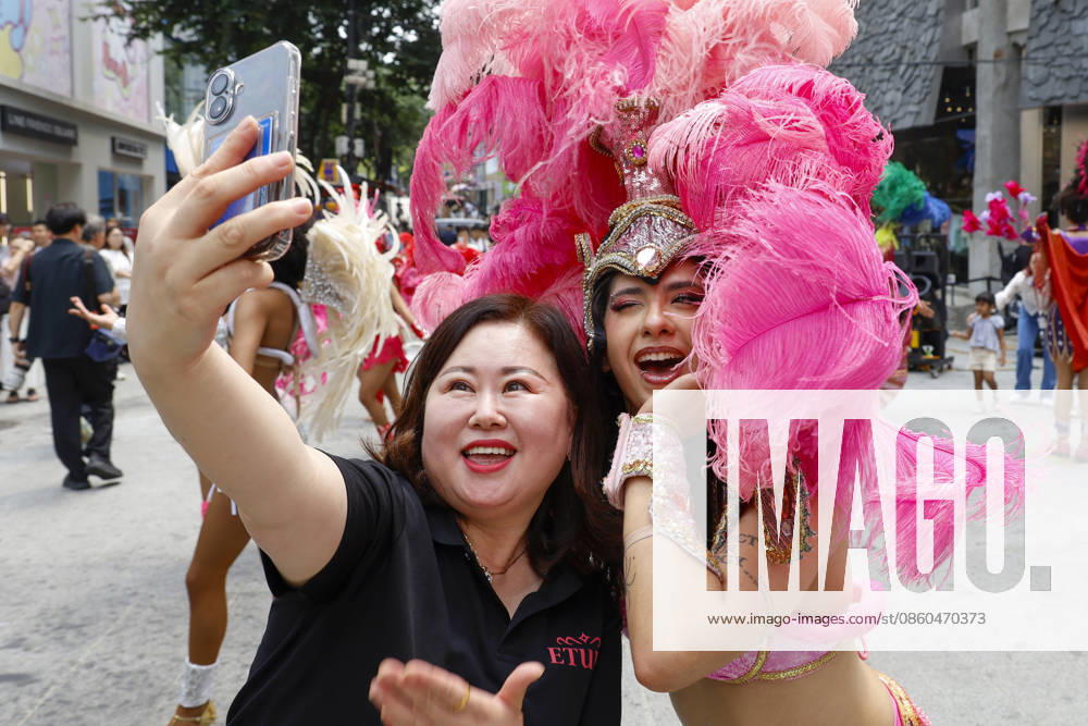 Dancers perform samba show summer festival in Seoul Dancers from Lotte World, a South Korean theme park, pose for photos with visitors after performing a samba show during a summer festival promotional event in the Myeongdong shopping district in Seoul, South Korea, on July 01, 2026. Seoul South Korea