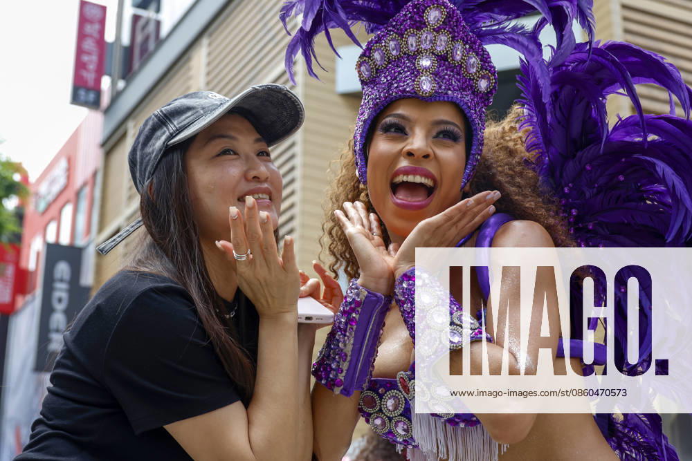 Dancers perform samba show summer festival in Seoul Dancers from Lotte World, a South Korean theme park, pose for photos with visitors after performing a samba show during a summer festival promotional event in the Myeongdong shopping district in Seoul, South Korea, on July 01, 2026. Seoul South Korea