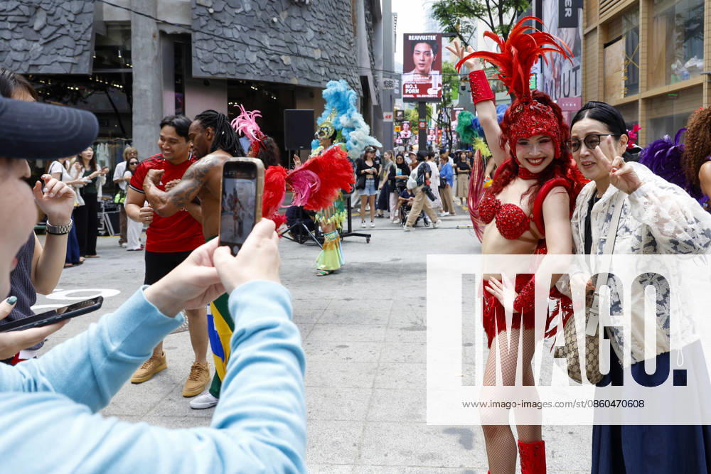 Dancers perform samba show summer festival in Seoul Dancers from Lotte World, a South Korean theme park, pose for photos with visitors after performing a samba show during a summer festival promotional event in the Myeongdong shopping district in Seoul, South Korea, on July 01, 2026. Seoul South Korea