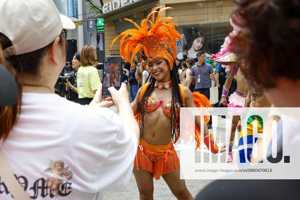 Dancers perform samba show summer festival in Seoul Dancers from Lotte World, a South Korean theme park, pose for photos with visitors after performing a samba show during a summer festival promotional event in the Myeongdong shopping district in Seoul, South Korea, on July 01, 2026. Seoul South Korea