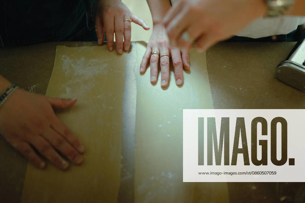 Several hands preparing fresh homemade pasta dough San Diego, California, United States R_QCYJ260625-2032431-01