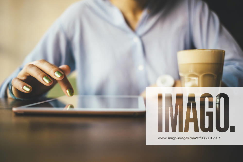 Woman sitting in a cafe using a digital tablet and drinking a coffee model released, Symbolfoto, OYF00054