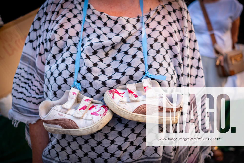 Activists from the group Health Workers for Gaza are holding a rally in front of Montecitorio, the Chamber of Deputies, to demand the release of Dr. Hussam Abu Safiya and all other Palestinian prisoners. Participant shows children s shoes stained with red paint to remember the high number of children victims of the conflict. Rome Italy - ZUMAg256 20260710_znp_g256_003