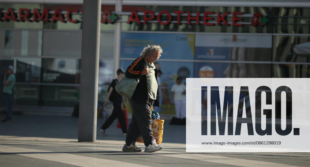 A homeless person walks across the plaza in front of Cologne Central Station, Cologne, North Rhine-Westphalia