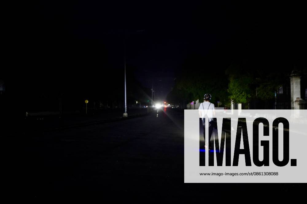 (260711) -- HAVANA, July 11, 2026 -- A man rides an electric scooter on a street during a blackout in Havana, Cuba, July 10, 2026. Cuba was hit by another nationwide blackout on Friday, as the country s power system completely collapsed at 4:30 p.m. local time, according to the National Electric Union. ) CUBA-HAVANA-NATIONAL BLACKOUT-STREET VIEWS JiangxBiao