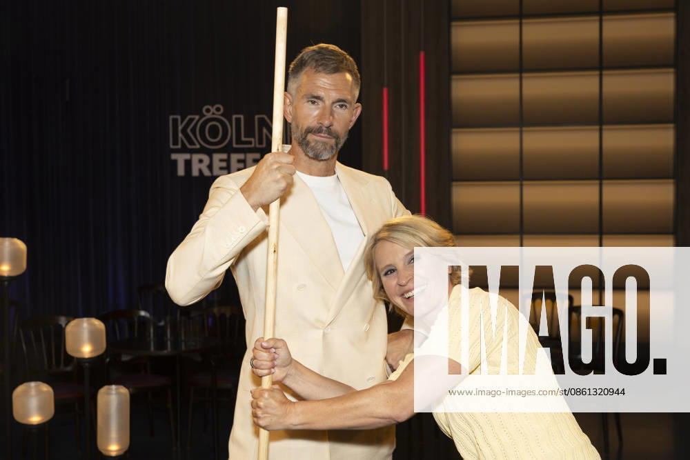 Host Micky BEISENHERZ (left) and host Susan LINK (right) hold onto a Shaolin Bo staff; portrait, portrait, from the TV show Koelner Treff on WDR television; recorded on July 10, 2026; Aired on August 7, 2026