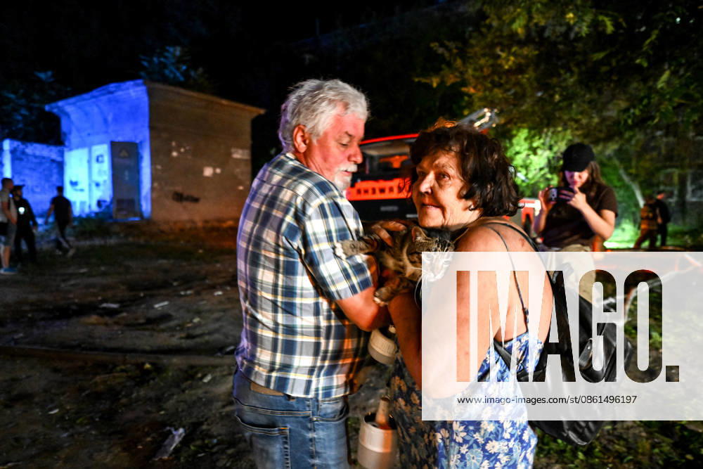 A woman holds a cat in her arms during emergency response efforts following a nighttime Russian drone attack in Zaporizhzhia, Ukraine, on July 12, 2026. Six people, including a 15-year-old boy, were injured in the attack (Photo by Dmytro Smolienko Ukrinform) Nighttime Russian drone strike hits Zaporizhzhia