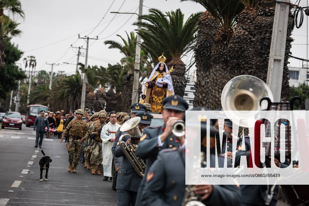 ARICA, CHILE †JULY 2026: Chilean soldiers carry an image of the Virgen del Carmen from the foot of the steps into San Marcos Cathedral, where it will remain for worshippers to venerate over the following days, while a Catholic priest looks on. This year marks 100 years since the Church crowned the Virgen del Carmen, Patroness of Chile. Ibar Silva JNA Press. Arica Chile - ZUMAq101 20260716_zna_q101_057
