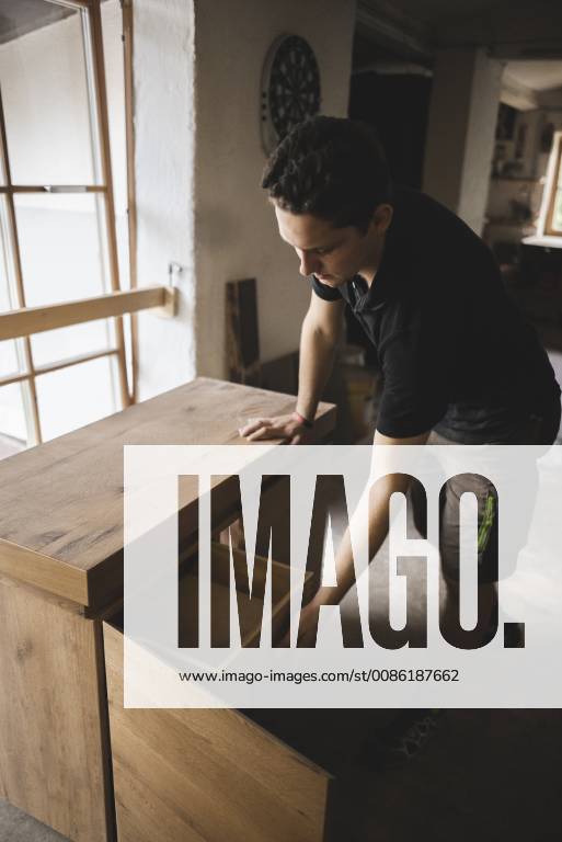 Carpenter in workshop testing chest of drawers model released Symbolfoto property released PSIF00053