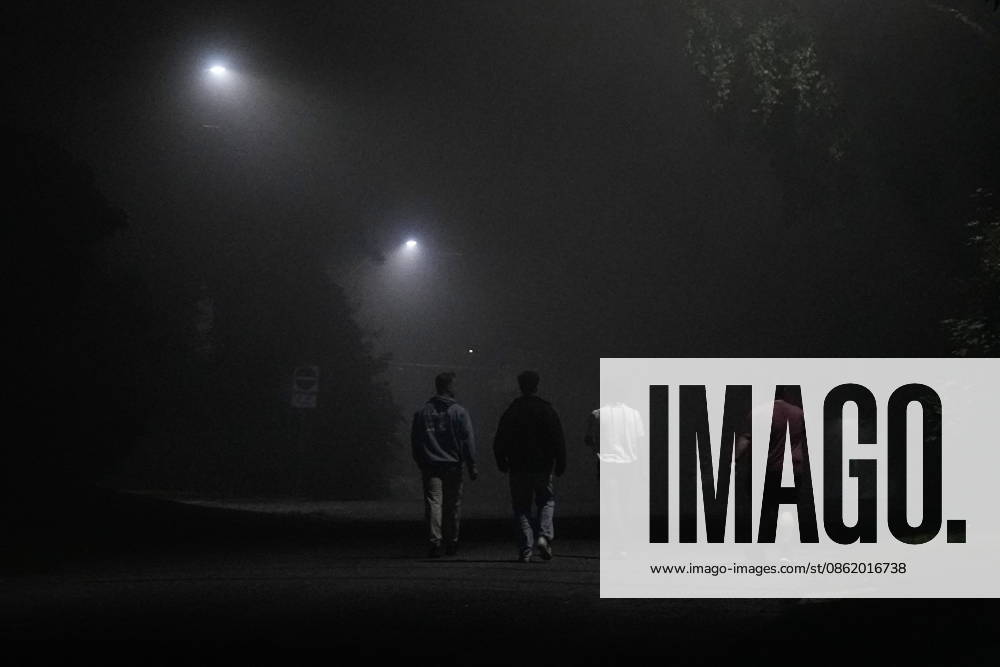 Thunder Bay, On, CAN: People walks down a side street, as smoke from wild fires fills the night air in Thunder Bay, Ont., Friday, July 17, 2026. Thunder Bay CAN - ZUMAc35_ 20260718_zaf_c35_013