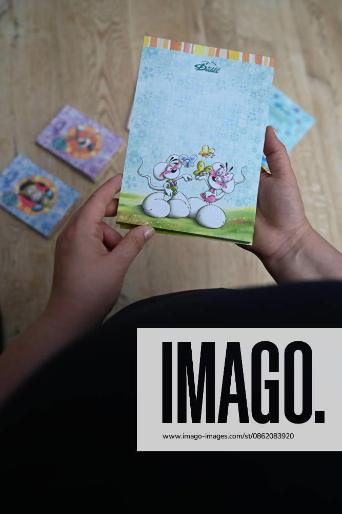 Diddl Makes a Comeback in Germany A woman holds a current Diddl notebook in her hand. After more than a decade, the iconic plush mouse is returning to the German market, prompting many people to look back nostalgically on their school days. Berlin, Berlin, Germany