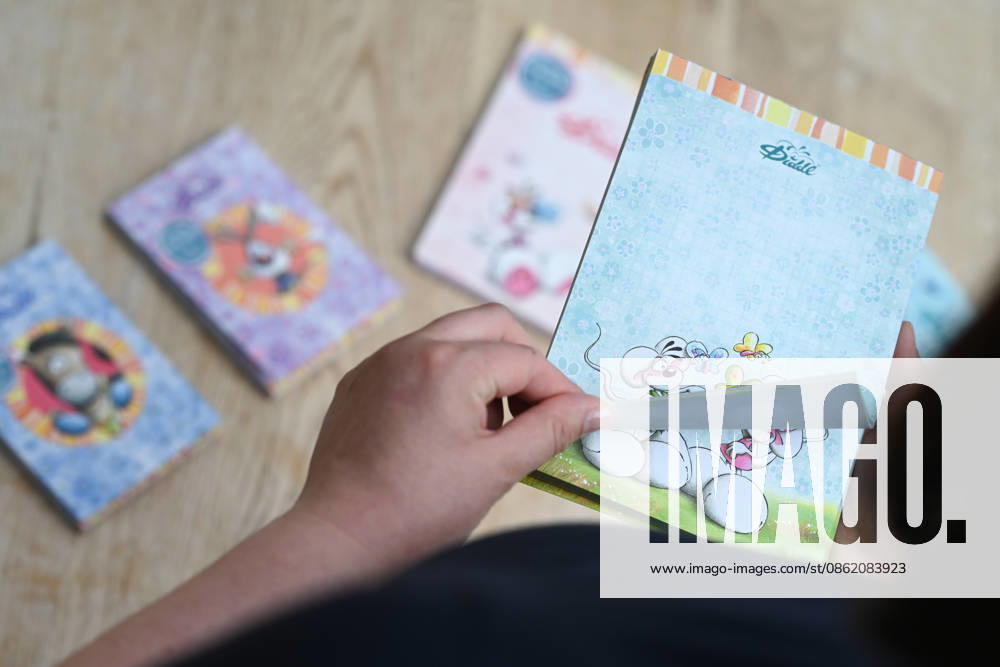 Diddl Makes a Comeback in Germany A woman holds a current Diddl notebook in her hand. After more than a decade, the iconic plush mouse is returning to the German market, prompting many people to look back nostalgically on their school days. Berlin, Berlin, Germany