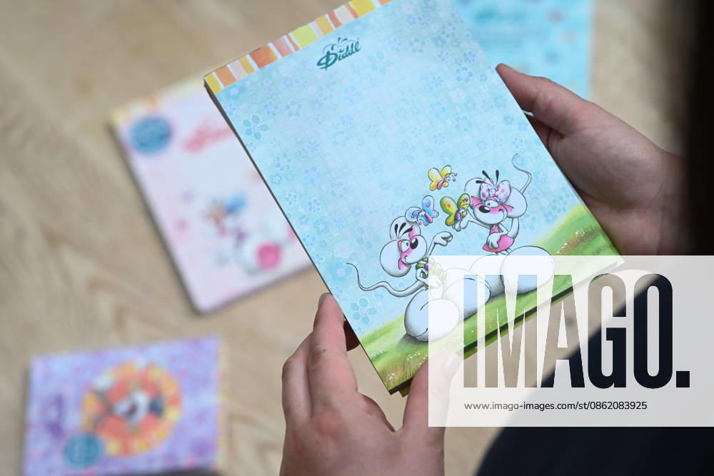 Diddl Makes a Comeback in Germany A woman holds a current Diddl notebook in her hand. After more than a decade, the iconic plush mouse is returning to the German market, prompting many people to look back nostalgically on their school days. Berlin, Berlin, Germany
