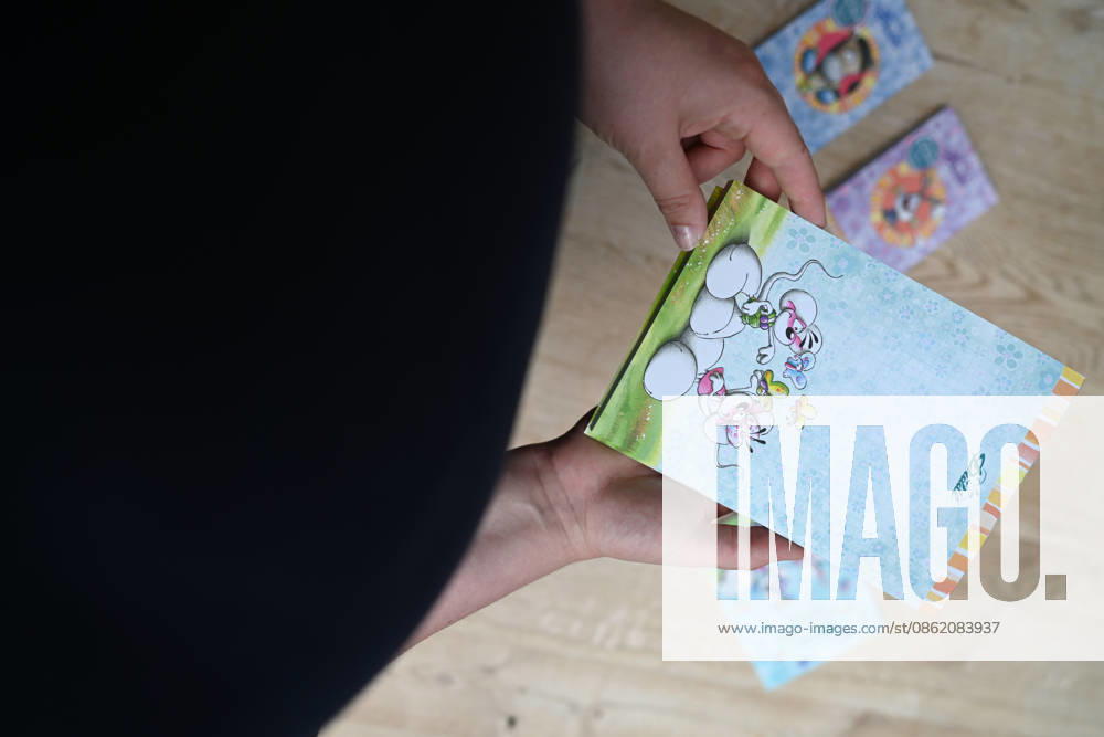 Diddl Makes a Comeback in Germany A woman holds a current Diddl notebook in her hand. After more than a decade, the iconic plush mouse is returning to the German market, prompting many people to look back nostalgically on their school days. Berlin, Berlin, Germany
