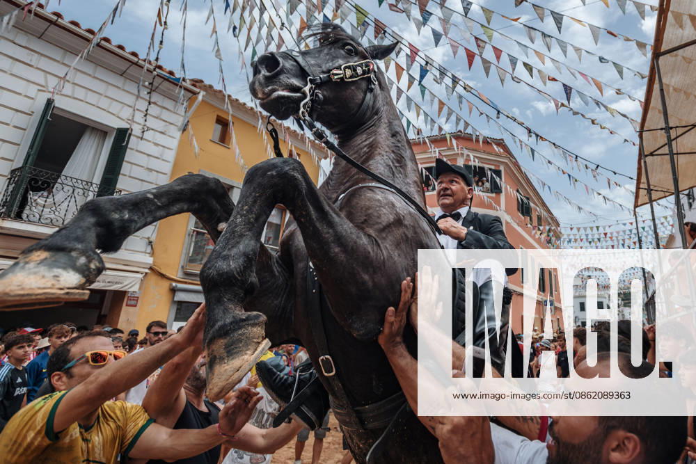 A caixer, or horse rider, rears his horse amid a cheering crowd during the traditional Jaleo at the Sant MartoÂ­ Festival in Es Mercadal. Es Mercadal Spain - ZUMAo105 20260719_fap_o105_029