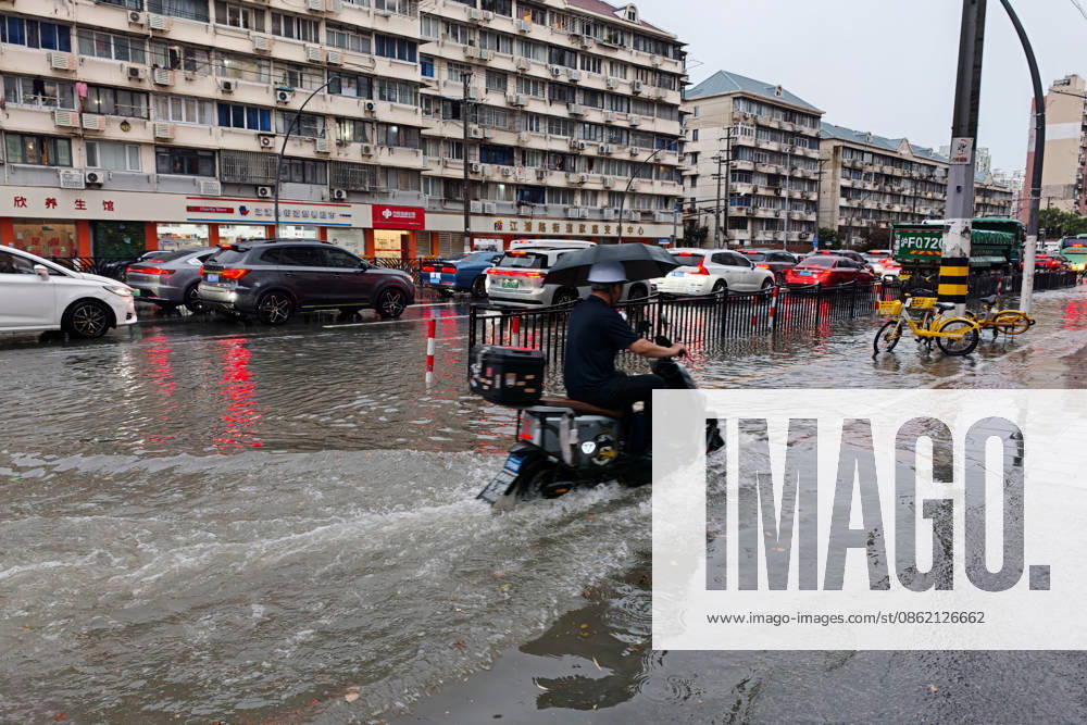 A motorcyclist drives through flooded street due to heavy rainstorms on July 19, 2026 in Shanghai, China. Shanghai Meteorological Observatory upgraded the rainstorm alert from yellow to orange for the central urban area at 14:35 on July 19.