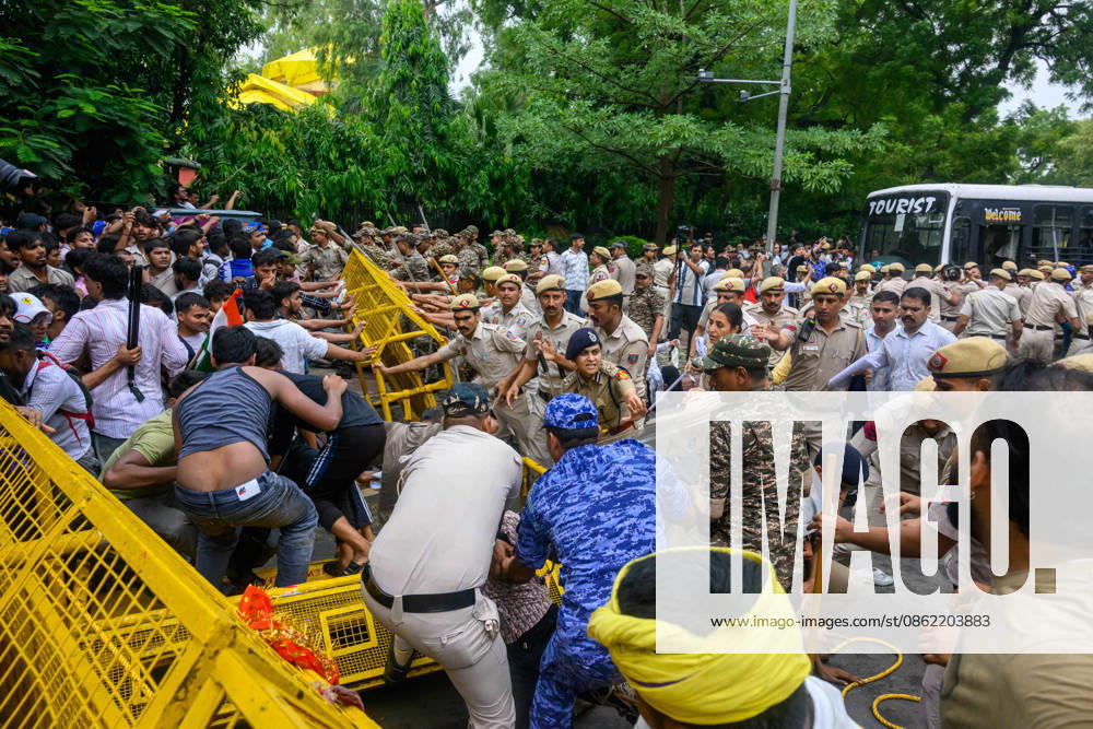 NEW DELHI, India � A large contingent of police move in as protesters and officers scuffle at a barricade, with one officer holding a riot shield, at Jantar Mantar during demonstrations by the Cockroach Janata Party (CJP) demanding the resignation of Education Minister Dharmendra Pradhan over alleged irregularities in the NEET-UG exam, July 20, 2026. New Delhi India - ZUMAm184 20260720_zip_m184_045