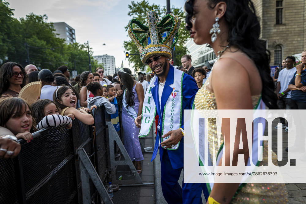 24 July 2026, Rotterdam, the Netherlands. The ZomerCarnaval king and queen dance and interact with the crowd. Competing in the Battle of Drums, three brass band groups†Rhythm Allstars Brass Band, S.L.R. Brass Band, and Latin Music Brass Band†perform during the Battle of Drums. This is the opening event of Rotterdam Unlimitedâ€⠢s Zomercarnaval 2026. Rotterdam Netherlands - ZUMAp202 20260724_zip_p202_011