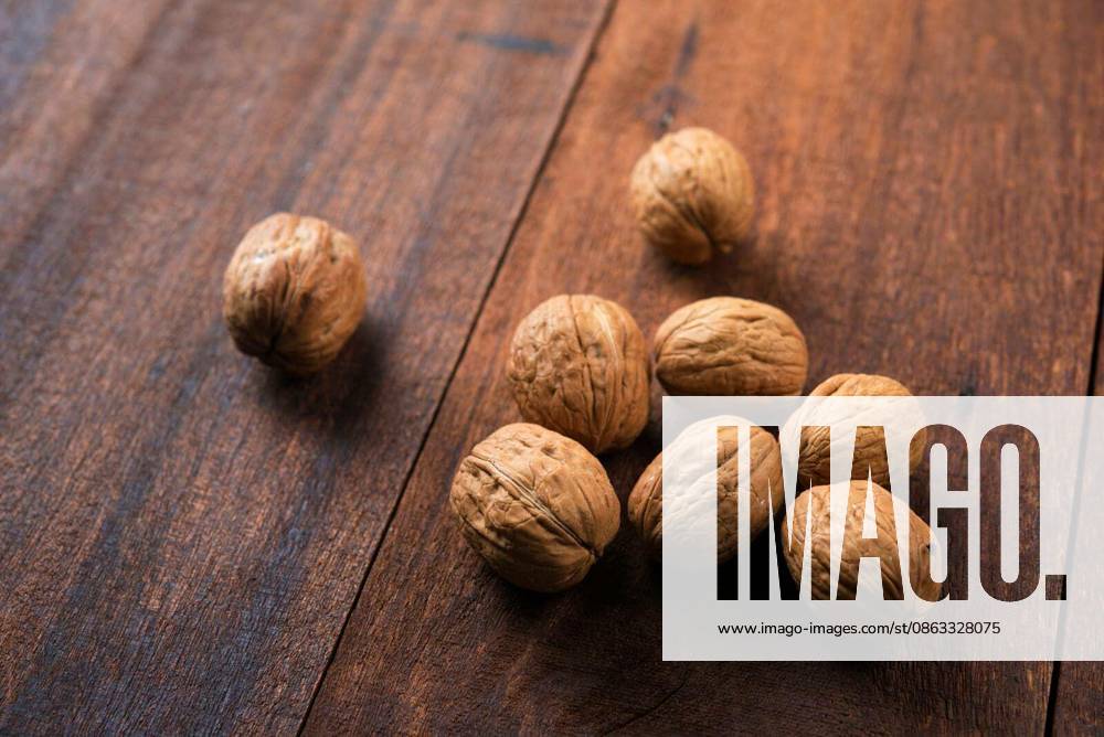 Walnuts shell on wooden table background.
