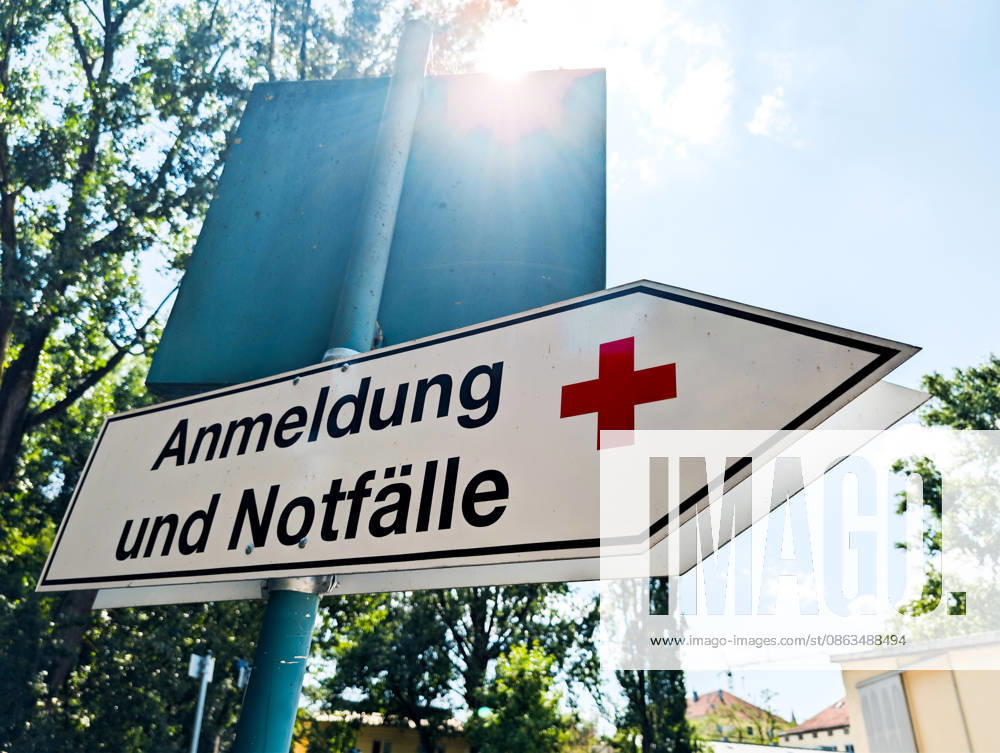 Signpost with a red cross symbolizing a hospital or medical facility bearing the inscription: Registration and Emergencies?