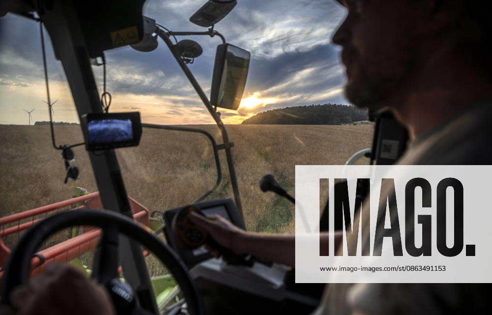Nuremberg: Combine Harvester at Dusk A farmer is harvesting a large rapeseed field near Burghaslach in Franconia, Bavaria, with his Claas Tucano combine harvester. Sometimes, from the driver’s cab, he catches a glimpse of romantic sunsets. During hot summers, there are often only a few days available for the harvest, which must be us