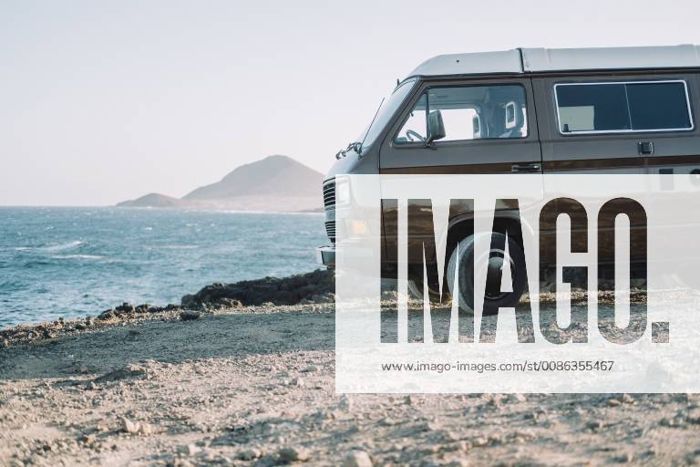 Vintage camper van parked on sandy beach by sea, Tenerife, Canary Islands, Spain, Tenerife Canary Islands Spain VISE004116