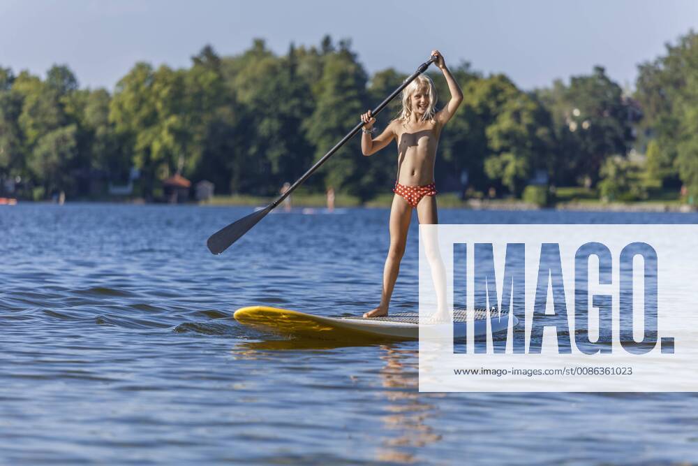 Young girl stand up paddle surfing model released Symbolfoto TCF05660