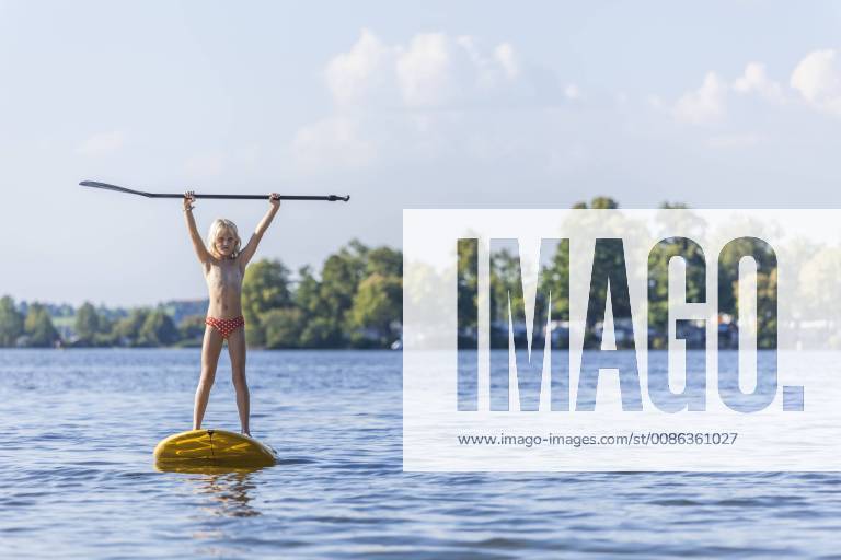 Young girl stand up paddle surfing model released Symbolfoto TCF05662