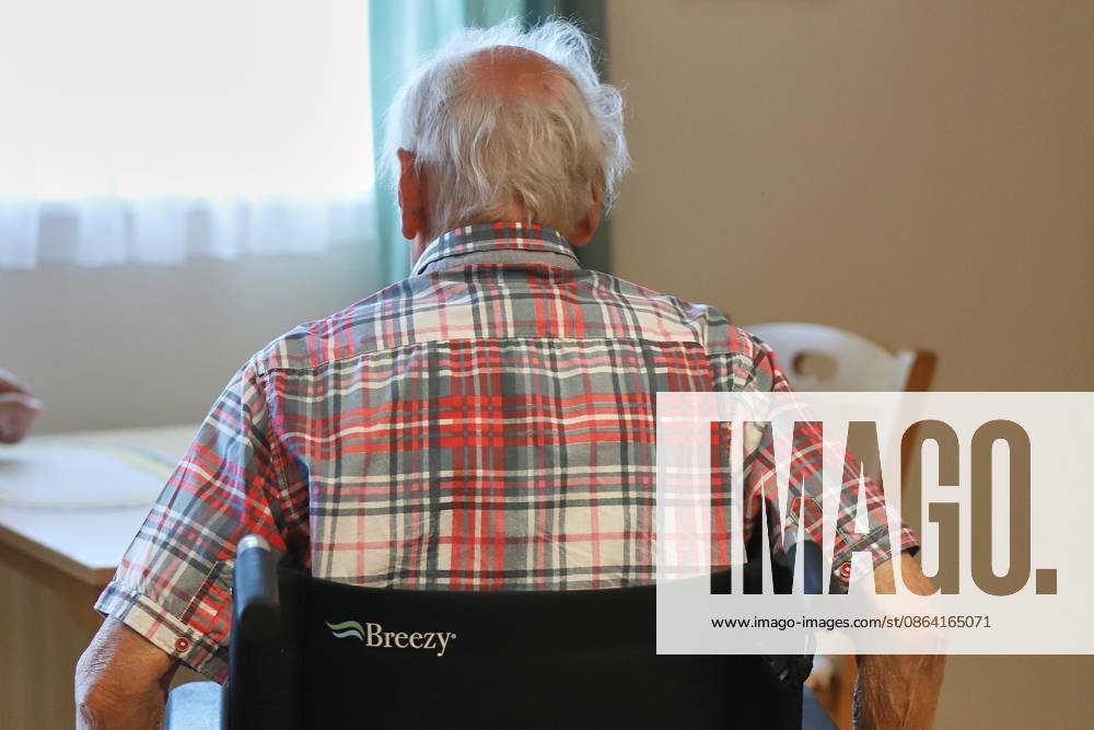 An elderly man in a wheelchair at a nursing home