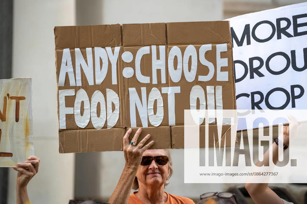 A Stop Rosebank activist holds a placard reading Andy choose food not oil during a demonstration outside the Treasury at Horse Guards road. Stop Rosebank activists staged a protest outside the Treasury highlighting the impact of prolonged heatwaves and drought on agriculture. Campaigners displayed empty harvesting baskets and a hessian sack labelled Wheat failed to represent damaged crops and poor harvests. Individuals held placards which read Oil Fuels Crop Failure, Rosebank Wont Feed Britain and Burnham Say No To Rosebank. The protest took place as the public consultation on the proposed Rosebank oil field closed with activists calling for the projec - ZUMAs197 20250817_aaa_s197_468