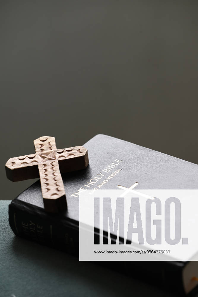 Hand-carved decorative wooden cross on a black leather Holy Bible cover. Religious artifact Bsip_016983_1064