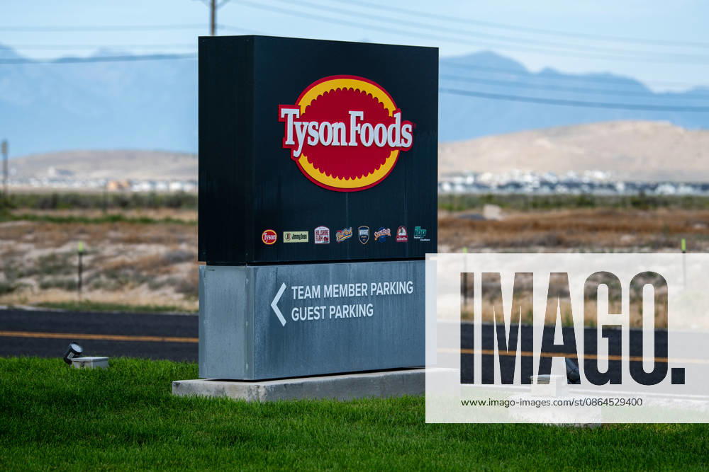 Tyson Foods Shuts Multiple U.S. Production Plants Amid Historic Cattle Shortages A roadside sign displaying the Tyson Foods logo and directional pointers for team member and guest parking is pictured at the entrance of the company s case-ready meat processing facility in Eagle Mountain, Utah, United States, on August 19, 2026. Tyson Foods, Inc. has accelerated a nationwide supply chain restructuring, permanently closing multiple major facilities across the country due to domestic livestock shortages and rising corporate operational losses. Eagle Mountain Utah United States