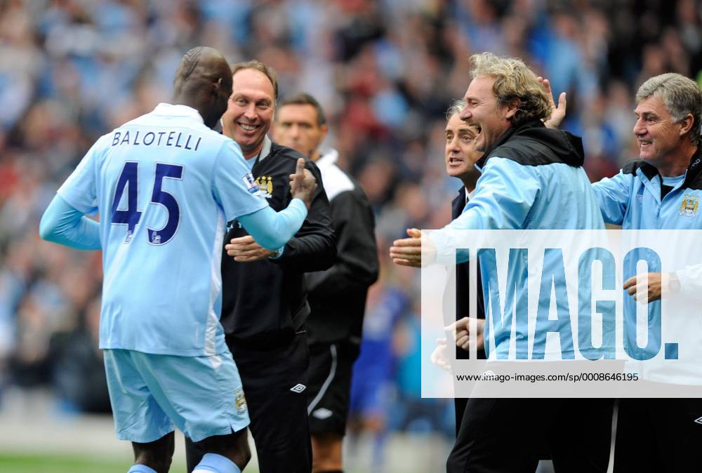 Mario Balotelli of Manchester City celebrates with the Manchester City coaching staff Barclays Premier League Manchester City v Everton 24th September, 2011 .
