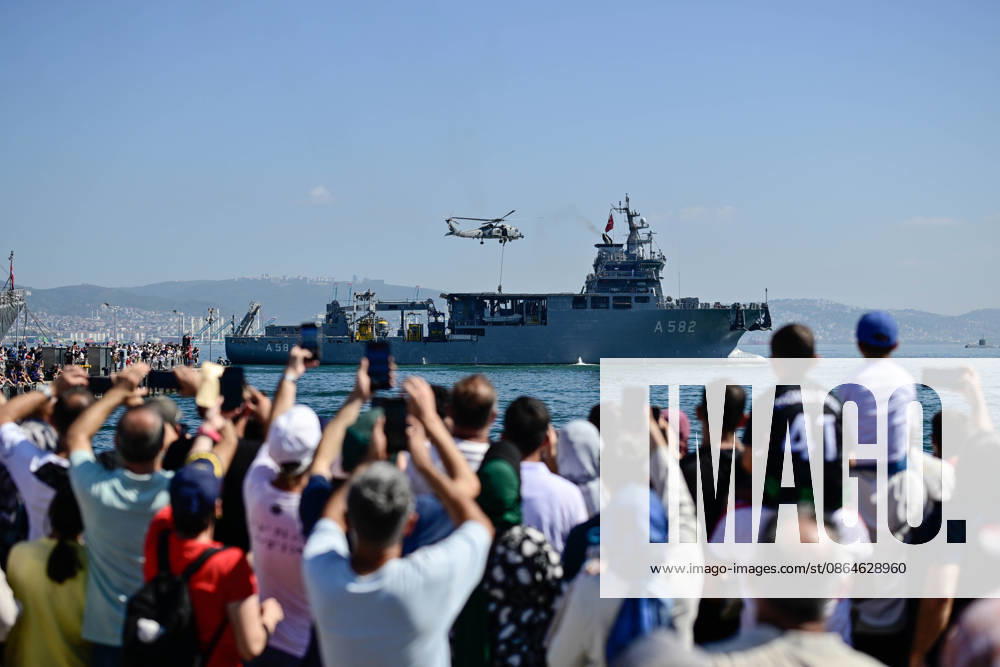 TEKNOFEST Blue Homeland KOCAELI, TURKIYE - AUGUST 23: Visitors watch a Turkish naval helicopter conduct a demonstration over the TCG Alemdar (A-582) submarine rescue mother ship during TEKNOFEST Blue Homeland at the Golcuk Naval Shipyard Command in Kocaeli, Turkiye, on August 23, 2026. The event is organized under the leadership of the Turkish Ministry of National Defense and the Turkish Technology Team Foundation (T3 Foundation), with Anadolu serving as its Global Communication Partner. Cem Tekkesinoglu Anadolu Kocaeli Turkey. Editorial use only. Please get in touch for any other usage.