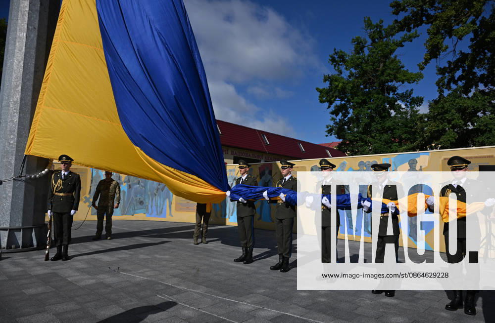 National Flag Day of Ukraine in Lviv LVIV, UKRAINE - AUGUST 23: Ukrainian servicemen hold a large national flag during a National Flag Day ceremony in Lviv, Ukraine, on August 23, 2026. Due to the ongoing Russian-Ukrainian War, celebrations were limited to a ceremonial raising of the Ukrainian flag on the city s highest flagpole with the participation of soldiers from various branches of the armed forces. Participants also observed a minute of silence for those killed, sang the Ukrainian national anthem, and listened to patriotic and folk songs performed by a military orchestra. Michael Sorrow Anadolu Lviv Ukraine. Editorial use only. Please get in touch for any other usage.