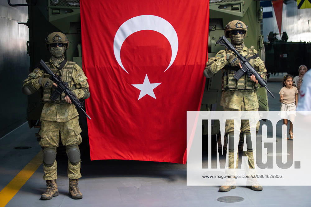 TEKNOFEST Blue Homeland KOCAELI, TURKIYE - AUGUST 23: Turkish soldiers stand guard beside a Turkish flag and an armored military vehicle displayed during TEKNOFEST Blue Homeland at the Golcuk Naval Shipyard Command in Kocaeli, Turkiye, on August 23, 2026. TCG Sancaktar carries out military missions including amphibious operations and mine-laying, and can also serve as a hospital, logistics support and evacuation ship in disaster zones. The event, organized under the leadership of the Turkish Ministry of National Defense and the Turkish Technology Team Foundation (T3 Foundation), with Anadolu serving as its Global Communication Partner, continues on its final day. Ibrahim Yozoglu Anadolu Kocaeli Turkey. Editorial use only. Please get in to