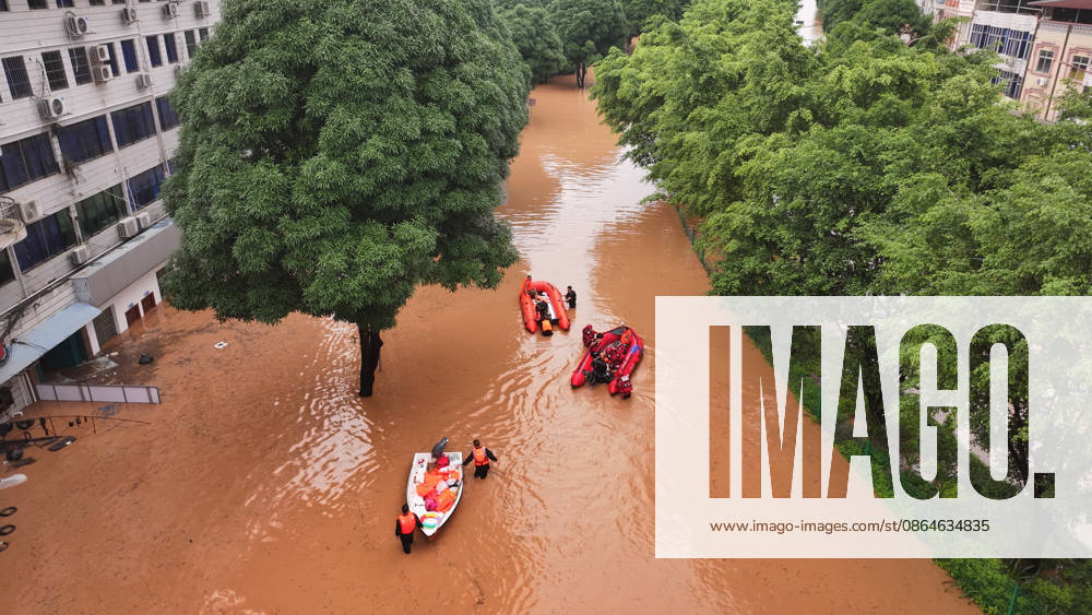 (260823) -- NINGMING, Aug. 23, 2026 -- An aerial drone photo taken on Aug. 23, 2026 shows rescuers transferring stranded residents in Ningming County, south China s Guangxi Zhuang Autonomous Region. For days, Ningming County has been battered by typhoon-triggered heavy rainfall. Response forces have pooled their efforts to urgently evacuate stranded residents. ) CHINA-GUANGXI-TYPHOON-STRANDED RESIDENTS-TRANSFER (CN) ZhouxHua