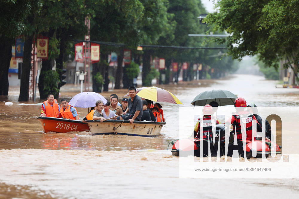Residents are evacuated by boat due to flooding caused by a typhoon on August 23, 2026 in Chengzhong Town, Ningming, Guangxi Zhuang Autonomous Region of China. Local authorities organized rescue forces to transfer residents to safe areas.