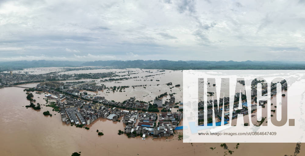 Residents evacuate in an orderly manner as floods hit Chengzhong Town, Ningming County, Chongzhi City on August 23, 2026 in Ningming, Guangxi Zhuang Autonomous Region of China. The flooding was caused by a typhoon affecting the region.
