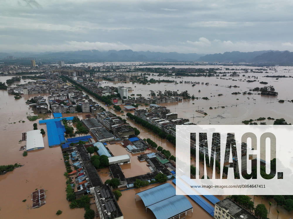 Residents evacuate as floodwaters hit the area due to a typhoon on August 23, 2026 in Ningming, Guangxi Zhuang Autonomous Region of China. Local authorities organized an orderly transfer of residents affected by the flooding.
