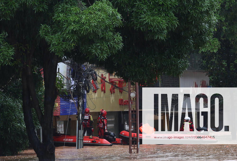Rescue workers evacuate residents by boat due to flooding caused by a typhoon on August 23, 2026 in Ningming, Guangxi Zhuang Autonomous Region of China. Local authorities organized rescue teams to inspect hazards and assist trapped residents in Chengzhong Town, Ningming County.