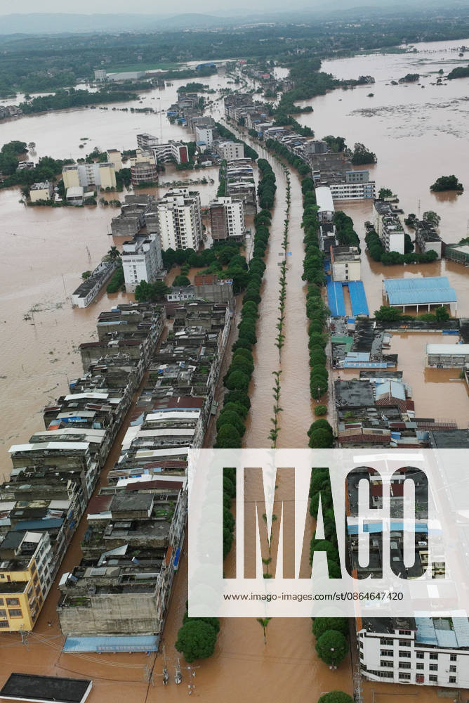 Residents evacuate in an orderly manner as floodwaters hit Chengzhong Town, Ningming County, Chongzhi City on August 23, 2026 in Ningming, Guangxi Zhuang Autonomous Region of China. The flooding was caused by a typhoon affecting the region.