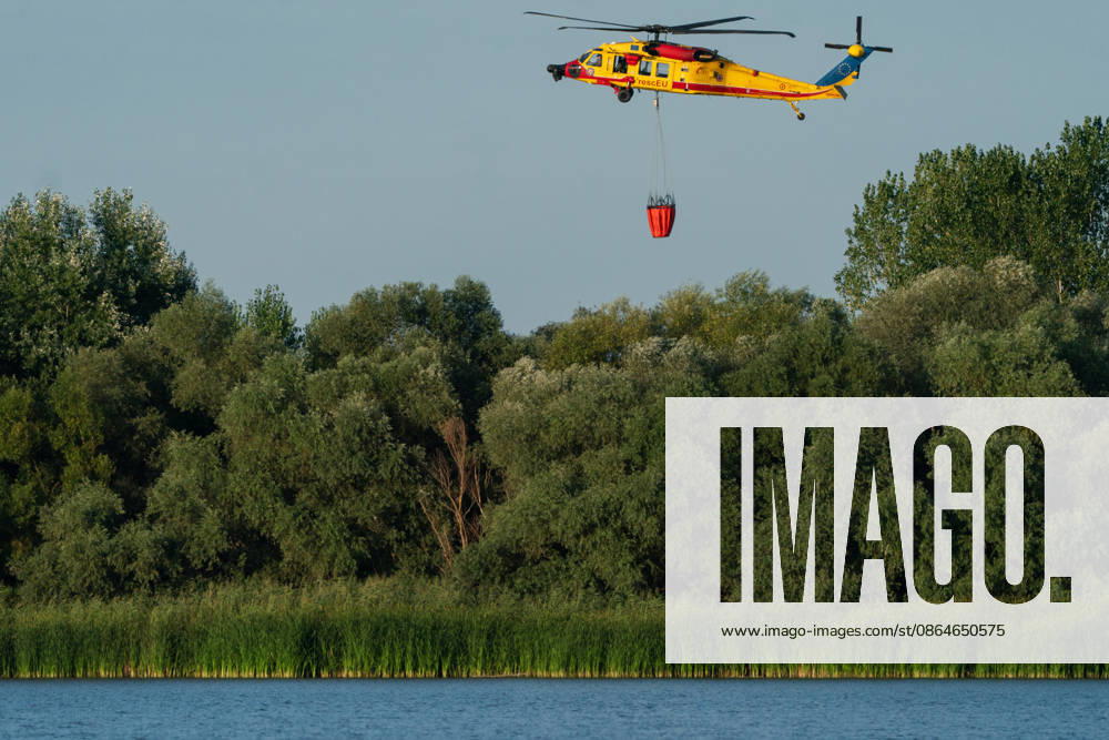 2026823, Kajtasovo, Serbia -The European Union is actively assisting Serbia in battling severe wildfires at Serbia s request through the EU Civil Protection Mechanism, deploying four firefighting helicopters from Romania, Slovakia, the Czech Republic, and Germany, alongside ground response teams to contain large blazes like the one in the Deliblato Sands. A Romanian rescEU Black Hawk helicopter. Kajtasovo Serbia - ZUMAd223 20260824_zip_d223_003