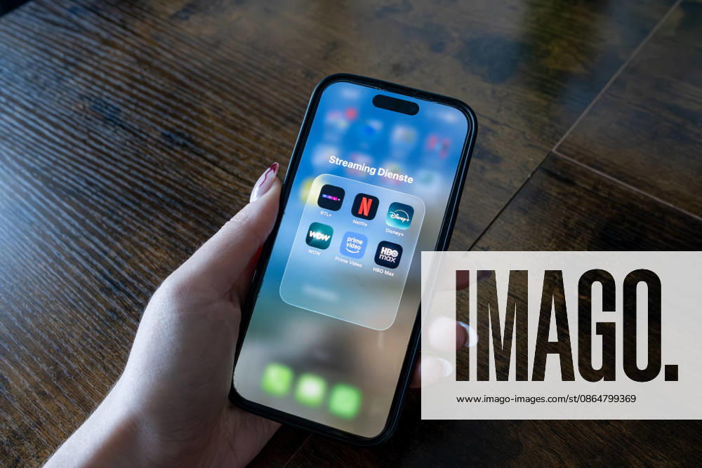 Streaming Services on a Smartphone May 26, 2018, Eisenbach Stock photo, illustrative image, stock image, illustrative photo, everyday scene A person is holding a smartphone in their hand. The screen shows a folder containing various streaming services such as Netfli