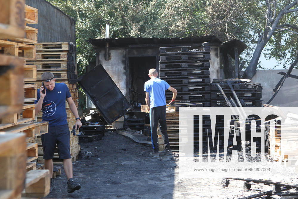 Men work at a parking lot, damaged by a nighttime Russian UAV attack, near a shopping and entertainment centre in Dnipro, Ukraine, August 25, 2026. Fires broke out inside and near the shopping mall as a result of the Russian attack. (Photo by Mykola Miakshykov Ukrinform) Russian attack hits parking lot near shopping mall in Dnipro suburb