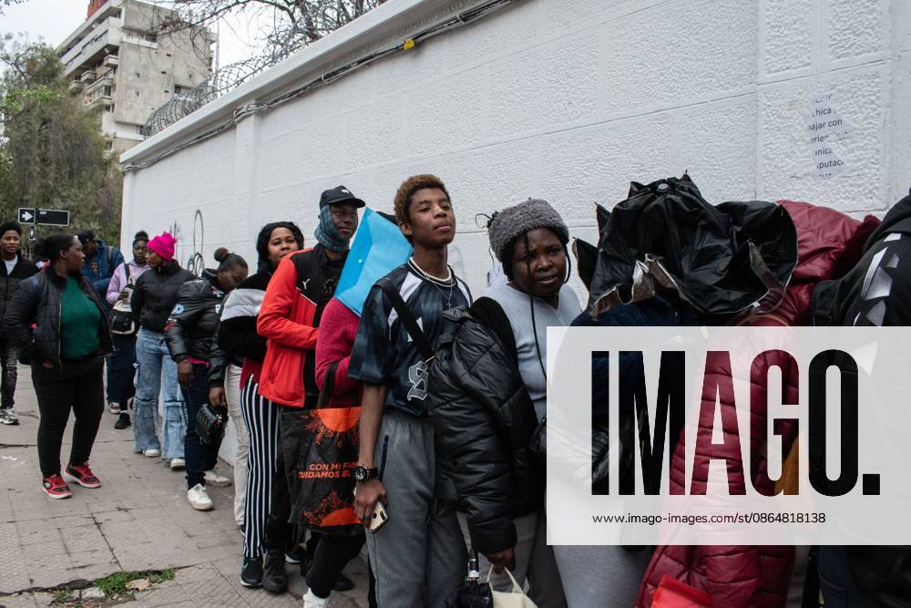 SANTIAGO, CHILE, AUGUST 25, 2026: Haitian citizens gather at the Consulate of Haiti in Santiago to complete paperwork related to the regularization of their immigration status in Chile. Santiago Chile - ZUMAq101 20260825_zna_q101_144