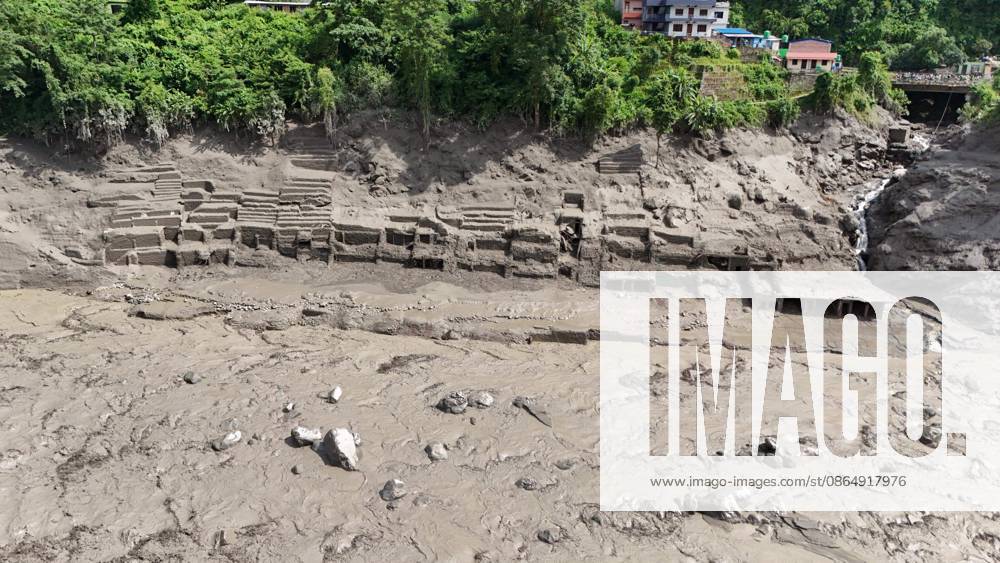 An aerial view shows buildings and infrastructure damaged along the swollen Trishuli River following a massive flash flood triggered by an avalanche of ice and rock in the upper Lhende River on the Tibetan side, in Nuwakot district, Nepal, on Wednesday, August 26, 2026. The sudden flood swept through communities along the Bhote Koshi and Trishuli river systems, destroying homes, roads and bridges and leaving widespread devastation downstream. Nuwakot Nepal - ZUMAg200 20260826_zap_g200_020