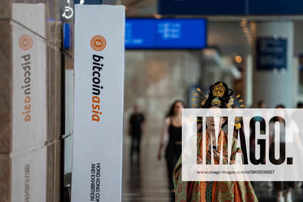 Bitcoin Asia Hong Kong 2026 A woman dress in a Chinese Hanfu walking next to a Bitcoin Asia logo at Bitcoin Asia 2026 on August 27, 2026 in Hong Kong. (Photo by Vernon Yuen Nexpher Images) HONG KONG